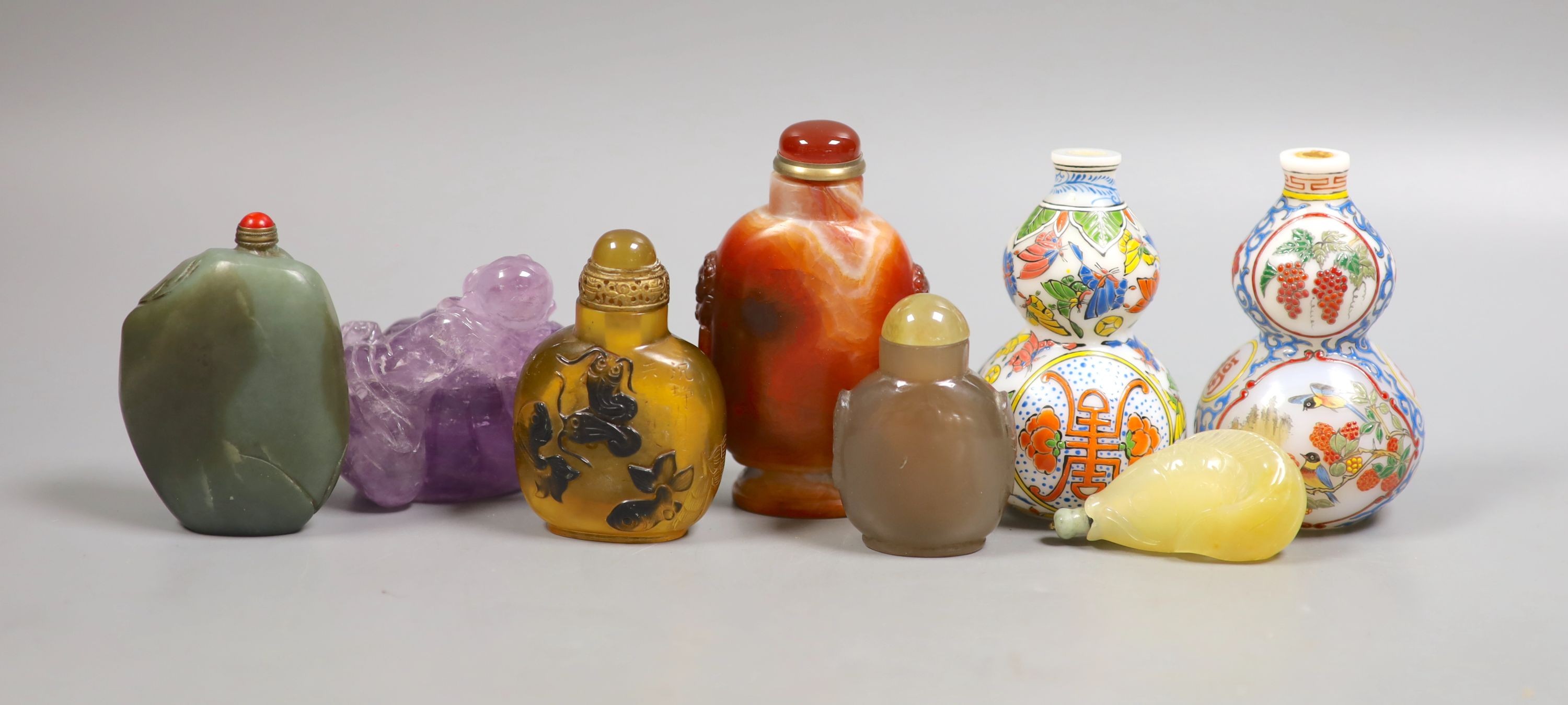 A group of Chinese jade, hardstone and glass snuff bottles, tallest 9.5 cm